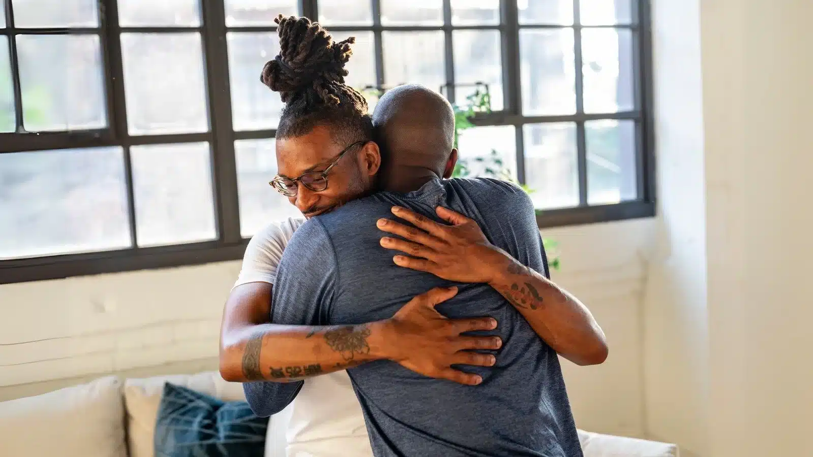 Men hugging each other after learning how ketamine therapy can be used to treat PTSD in San Antonio, Texas.