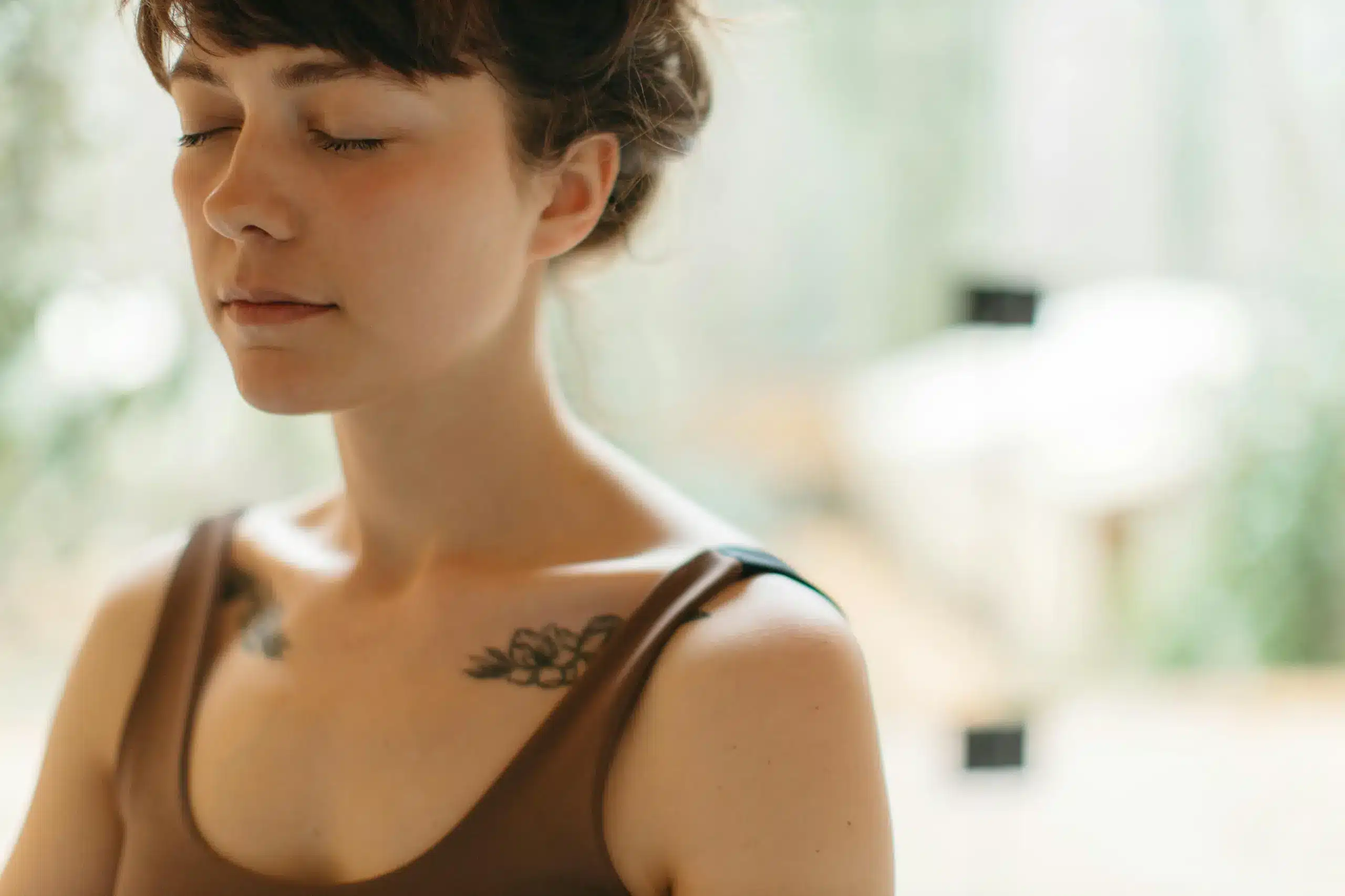 A peaceful woman with closed eyes representing calm achieved through Ketamine for Tourette’s Syndrome treatment.